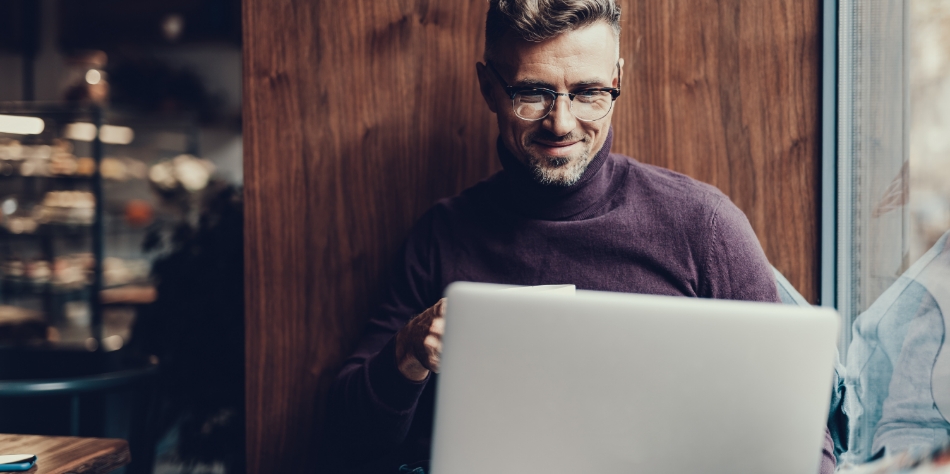 Man reading a blog on his laptop