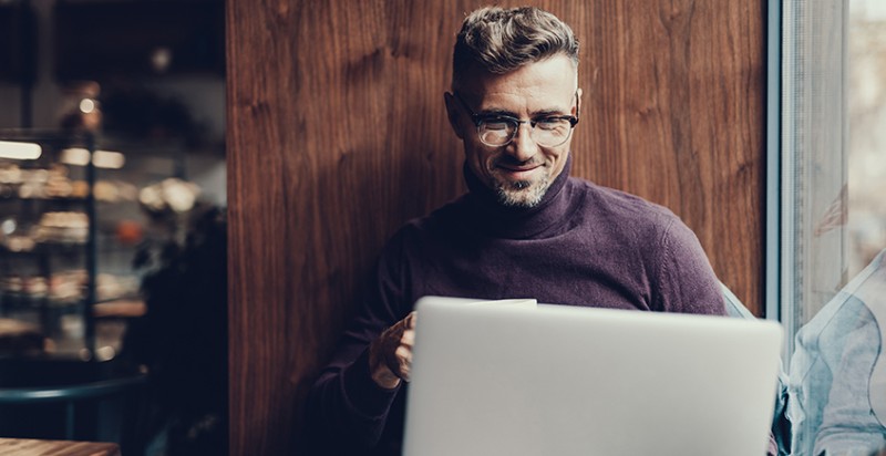 Man sitting on a laptop signing up for our newsletter