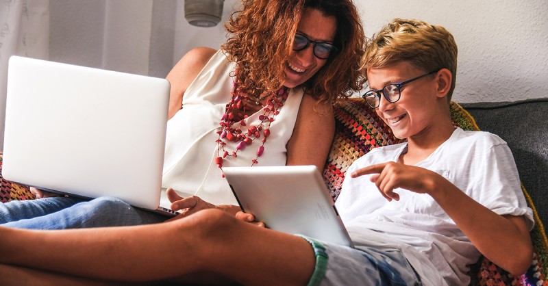 Screen Time - Beautiful teen reading new trend stories online on tablet with mum