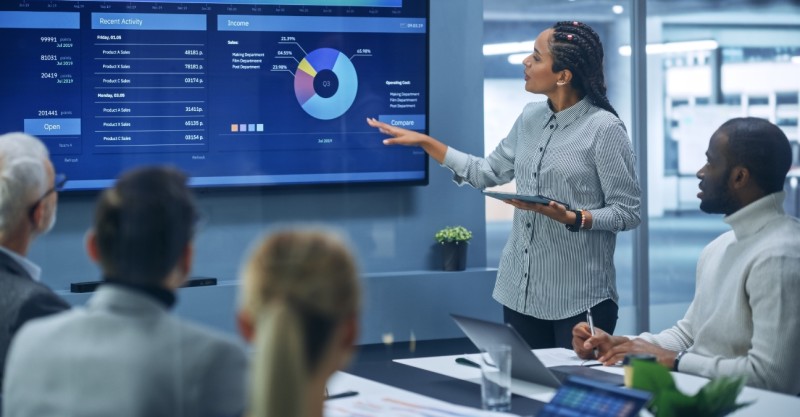 Woman demonstrating services in a meeting room